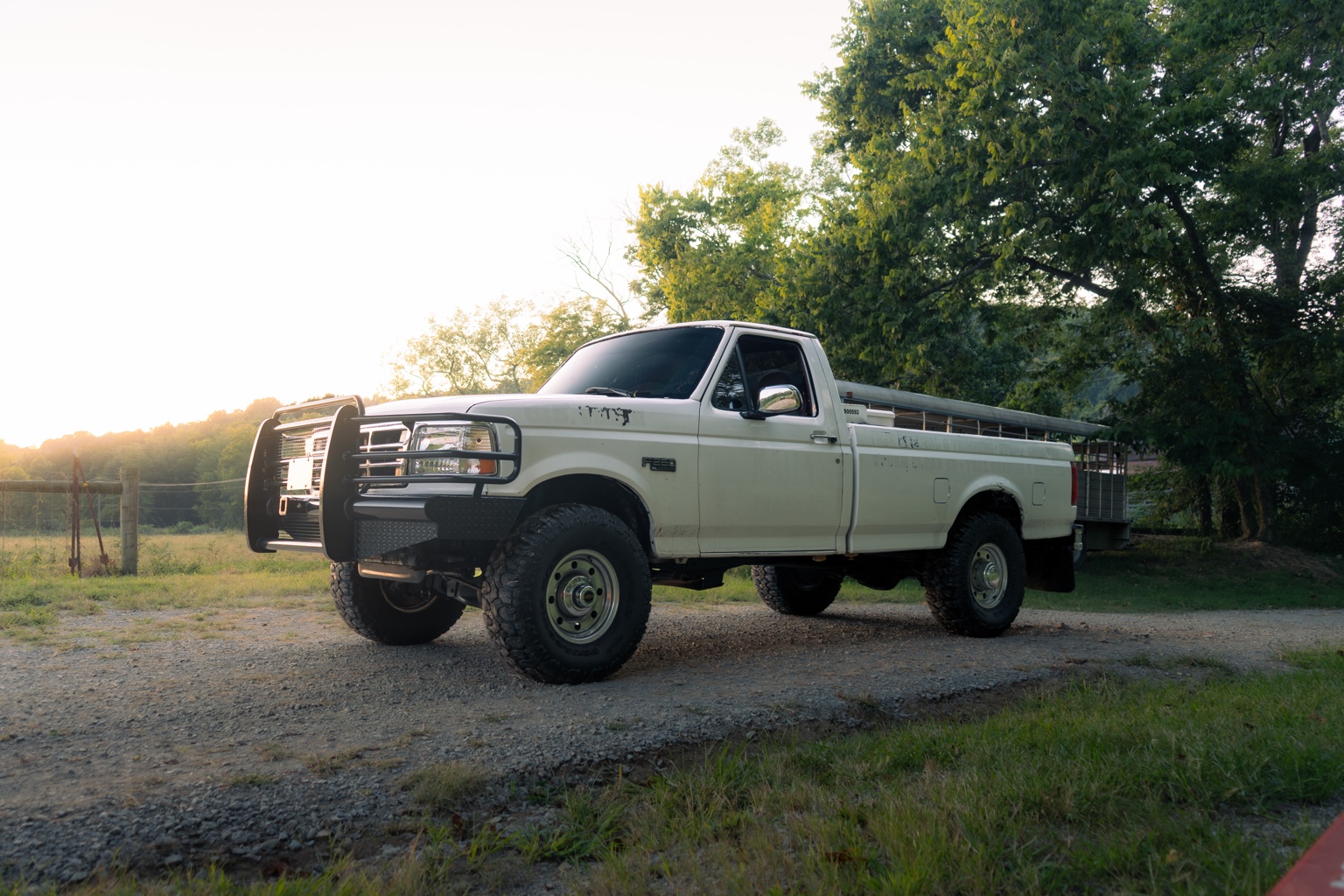 White Ford pickup at golden hour