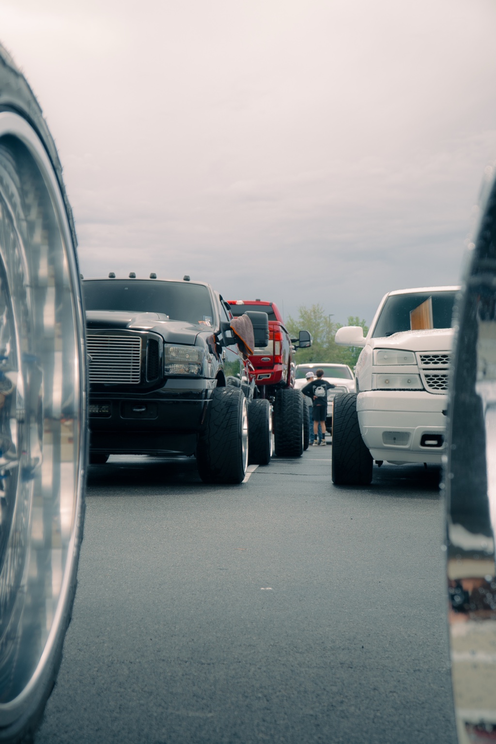 Low-angle view through a truck-show lineup