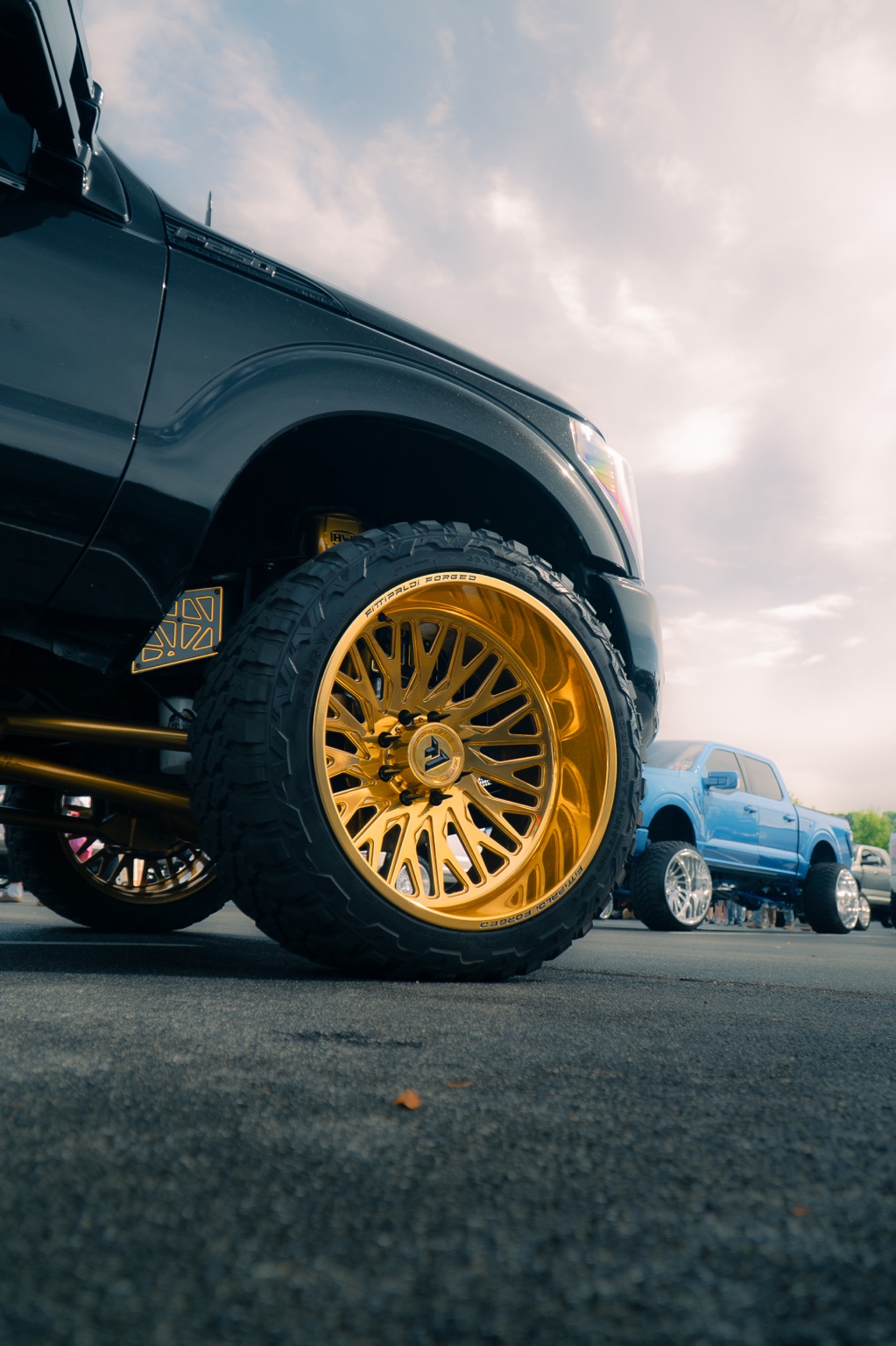 Gold wheel on a black custom truck
